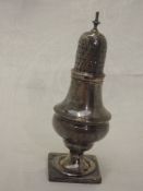 A Georgian silver caster of waisted baluster form having square pedestal foot and pierced push on