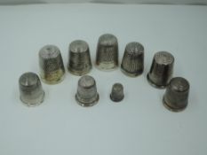 Nine HM silver and white metal thimbles of traditional forms including a miniature version, approx