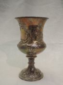 A Georgian silver chalice having flared rim, floral scroll repousse decoration on a reeded column