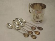 A small silver tankard of plain form having pedestal foot, rollover rim and monogrammed date to