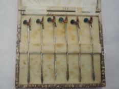 A cased set of six silver cocktail sticks having enamelled cockerel finials, Birmingham 1929, Adolph