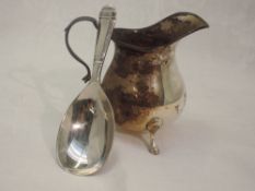 A silver caddy spoon, Sheffield 1952, Pinder Brothers, and a small Edwardian silver cream jug of
