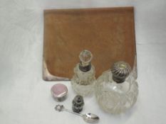 A small selection of HM silver including cut glass perfume bottles having silver collars and lids,