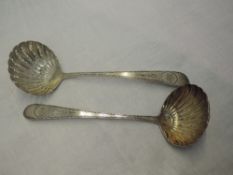 A pair of Irish Georgian silver sauce ladles having bright cut decoration to stems with