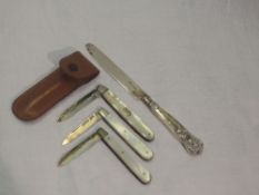 Two Edwardian folding fruit knives having HM silver blades and mother of pearl handles, a similar