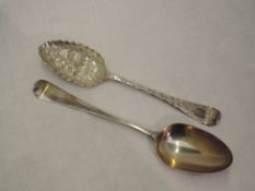 A Georgian silver berry spoon having frilled rim to bowl and later chased stem, London 1749,