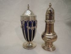 An Edwardian silver sugar caster having cage style body with blue glass liner and floral swag