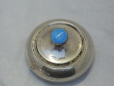 A silver dressing table powder pot of plain circular form with blue enamel guilloche decoration to