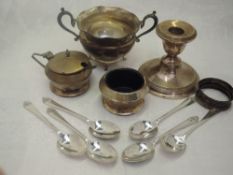 A selection of HM silver including a squat candle stick, mustard and salt, sugar bowl and set of six