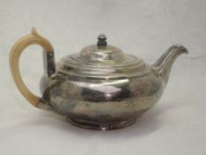 A Georgian silver teapot of plain squat circular form having ivory handle, scallop shell detail to