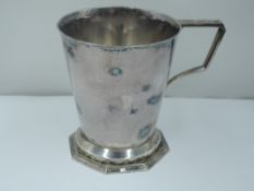 An Art Deco silver christening mug of plain conical form having architectural handle, stepped