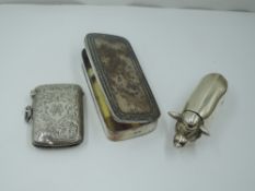 An HM silver vesta case having engraved scroll decoration and monogrammed cartouche, a white metal