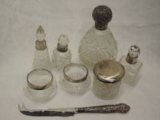 A selection of cut glass dressing table and scent bottles having HM silver collars/lids, and a