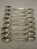 A velvet covered case in the form of a book containing fifteen Georgian silver teaspoons,