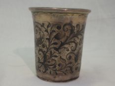 A Russian silver beaker having niello foliate scrolling decoration, flared rim and gilt interior,