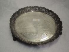 A Victorian silver card tray having heavily embossed raised rim, engraved decoration, initialled