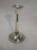 A silver candle stick of plain column form bearing monogram to weighted base, Birmingham 1913,