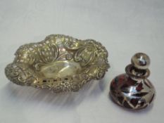 A Victorian silver trinket dish having embossed and pierced decoration and bun feet, Birmingham
