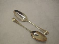 A pair of George II silver table spoons of hanovarian form having fan pattern to reverse of bowls