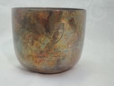 An Edwardian silver beaker of plain form having weighted base and hammered finish, and bearing