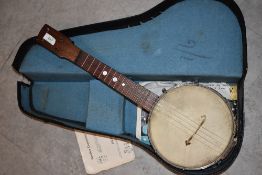 An early 20th Century ukulele banjo , in semi hard case, no makers mark, retail stamp to back of
