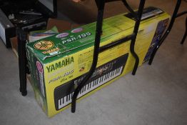 A Yamaha PSR-195 electronic keyboard, boxed, and a Stagg stand