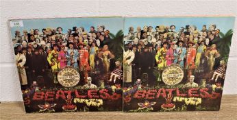A lot of two copies of the Beatles Sgt Pepper album with one being a later issue and the other a