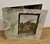A copy of Led Zeppelin's 4th / Untitled album- this is an 80's press but has a signature from singer