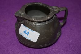 A small antique pewter jug stamped Tudric to base possibly Liberties and co having age related