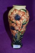 A Moorcroft baluster vase having cream and blue ground with stylised orange flowers.circa 2000.
