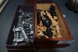 Four pivoting cannons, a box of chess pieces and a semi precious stone pendant.