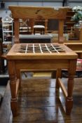 A modern pine low rail back dining chair