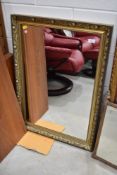 A decorative gilt framed wall mirror, approx. 87 x 60cm