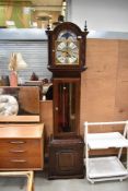 A reproduction long case clock having glazed panel to front