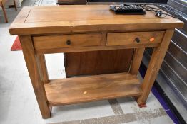 A modern hardwood side table having two frieze drawers, width approx. 91cm