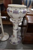 A late 19th/early 20th Century ceramic jardiniere and stand, unfortunately cracked throughout