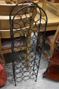 A modern metal framed wine rack holds approx 28 bottles