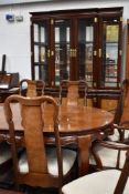 A modern Oriental hardwood bookcase having brass clasps and handles, width approx. 160cm height