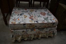 A modern upholstered footstool