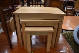 A modern golden oak effect nest of three occasional tables
