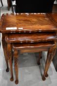 A nest of hardwood tables having carved Bohemian styled legs