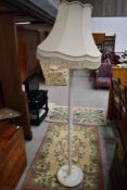 A traditional painted standard lamp and shade