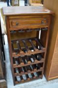 A modern hardwood wine rack (16 bottles) with frieze drawer