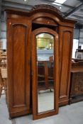 A Victorian mahogany wardrobe having central mirror door, width approx 143cm
