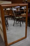 A pine framed wall mirror having bevel edged glass
