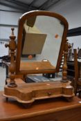 A Victorian toilet mirror on drawer base, light stain, some historical worm been treated