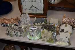 A collection of Lilliput lane style cottages and similar ceramic ones.