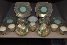 Around forty items of Plant Tuscan china having intricate gilt pattern throughout with green