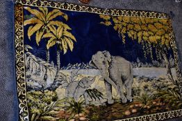 A large wool or wool blend rug or tapestry depicting scene of elephants and landscape.