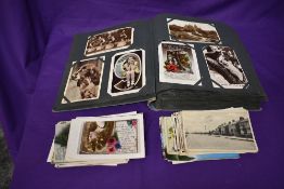A collection of Postcards in album and loose including Street Scenes, Greeting Cards, Vintage,